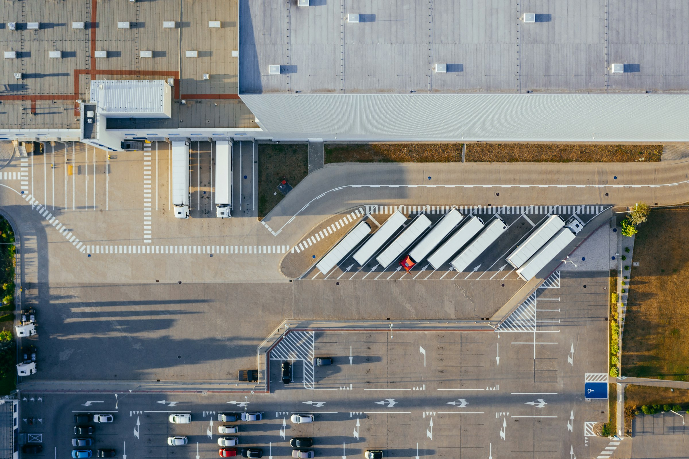 Aerial view of a large distribution hub with lorries at loading bays, representing a scalable, repeatable channel process across Asia Pacific